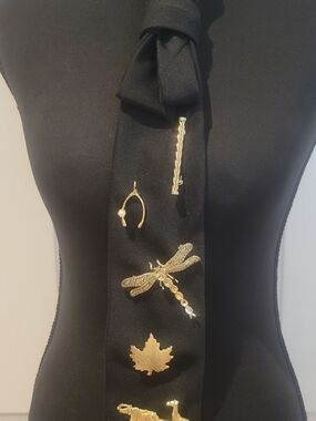Black Tie Adored with Multiple Gold Brooches and Pins